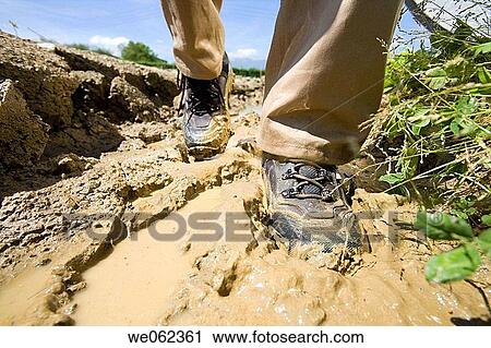 Stock Image - Waterproof protective boots, field. Fotosearch