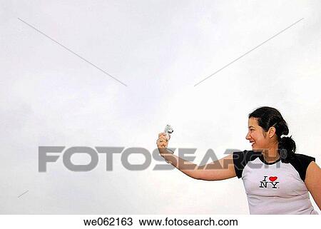 Woman holding a digital camera. T-shirt reads? I love New York?. View Large Photo Image Stock Image - Woman holding a digital camera. T-shirt reads? I love New York?.. Fotosearch