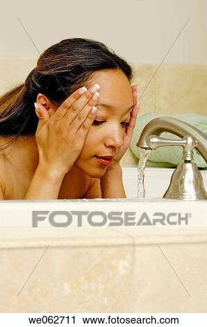 Woman washing face View Large Photo Image Stock Image - Woman washing face. Fotosearch