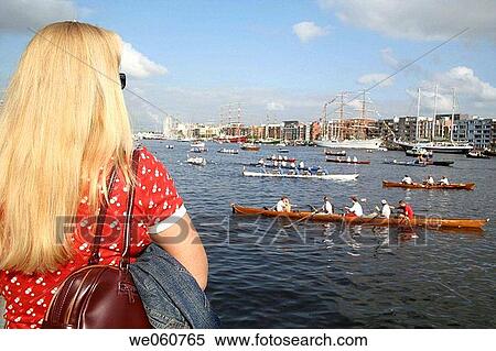 Woman watching rowing boats in IJ_Haven, Veemkade, Amsterdam, Sail 05, Holland, Netherlands View Large Photo Image Stock Photography - Woman watching rowing boats in IJ_Haven, Veemkade, Amsterdam, Sail 05, Holland, Netherlands. Fotosearch