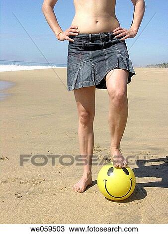 Woman with a smiling face ball in the beach View Large Photo Image Stock Image - Woman with a smiling face ball in the beach. Fotosearch