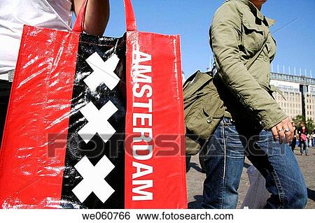 Woman with Amsterdam bag on Dam square in Amsterdam, Holland, Netherlands View Large Photo Image Stock Photograph - Woman with Amsterdam bag on Dam square in Amsterdam, Holland, Netherlands. Fotosearch
