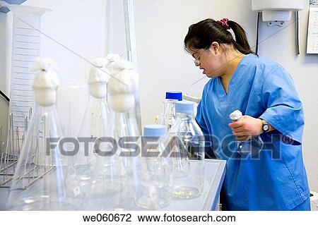 Stock Image - Worker with down's syndrome, sterilization area, biopharmaceutical lab, Grupo Genetrix, Madrid. Fotosearch