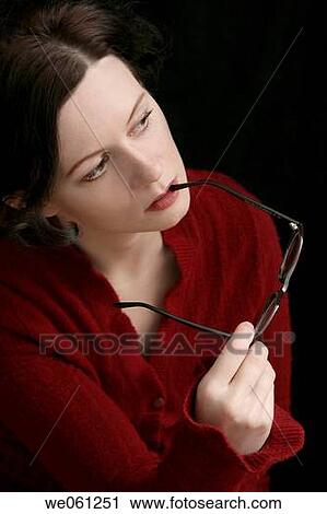 Stock Image - Young beautiful woman in red with a glasses. Fotosearch