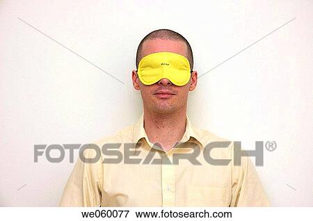 Young businessman gabbing a moments shut eye wearing an eye mask. View Large Photo Image Stock Photo - Young businessman gabbing a moments shut eye wearing an eye mask.. Fotosearch