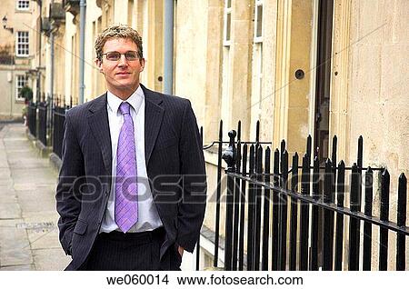 Young businessman in street of Georgian period architecture. Shot in Bath, United Kingdom. View Large Photo Image Picture - Young businessman in street of Georgian period architecture. Shot in Bath, United Kingdom.. Fotosearch