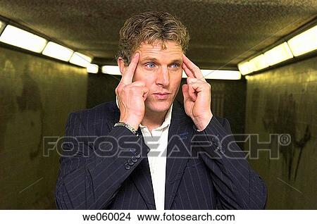Young businessman in urban underpass trying to concentrate. View Large Photo Image Picture - Young businessman in urban underpass trying to concentrate.. Fotosearch