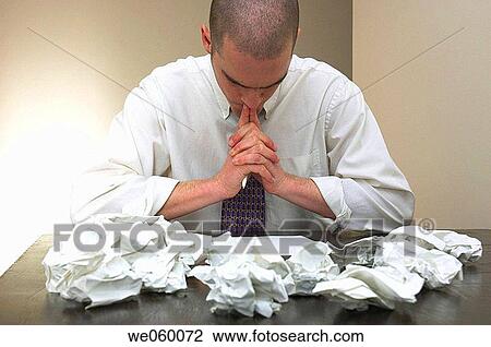 Young businessman struggling with some paperwork and expressing frustration in his body language. View Large Photo Image Stock Image - Young businessman struggling with some paperwork and expressing frustration in his body language.. Fotosearch