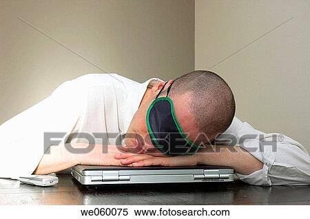 Young businessman taking power nap, resting his head on his laptop computer. View Large Photo Image Stock Photography - Young businessman taking power nap, resting his head on his laptop computer.. Fotosearch
