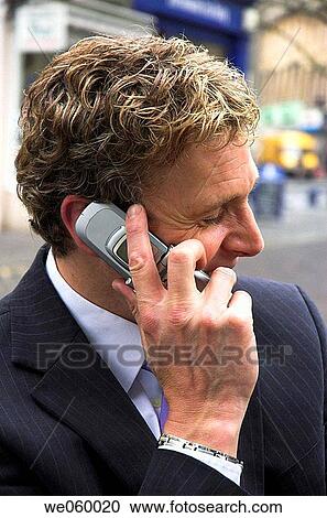 Young businessman using a mobile phone View Large Photo Image Stock Image - Young businessman using a mobile phone. Fotosearch