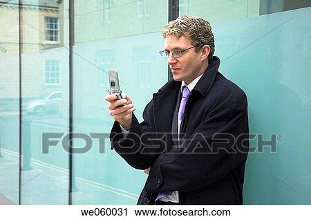 Young businessman using a mobile phone. View Large Photo Image Stock Image - Young businessman using a mobile phone.. Fotosearch