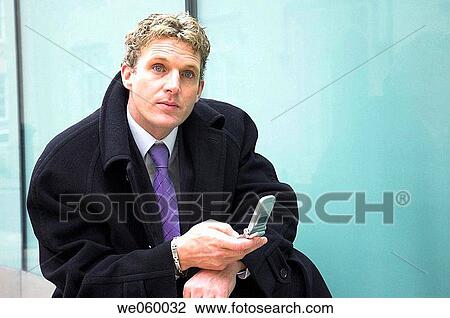 Young businessman using a mobile phone. View Large Photo Image Stock Image - Young businessman using a mobile phone.. Fotosearch