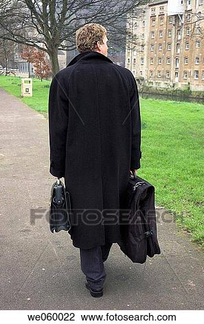 Young businessman walking with briefcase and overnight bag. View Large Photo Image Stock Image - Young businessman walking with briefcase and overnight bag.. Fotosearch