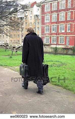 Young businessman walking with briefcase and overnight bag. View Large Photo Image Stock Image - Young businessman walking with briefcase and overnight bag.. Fotosearch