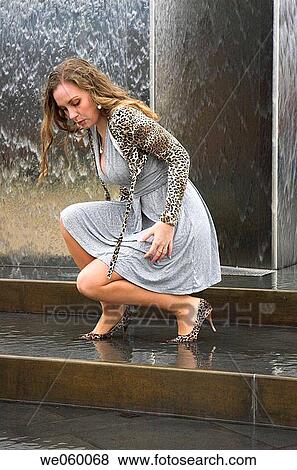 Young female fashion model posing in a fountain. View Large Photo Image Stock Photo - Young female fashion model posing in a fountain.. Fotosearch