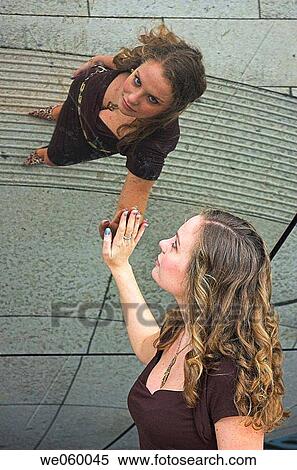 Young female fashion model posing in urban environment with mirrored surface View Large Photo Image Stock Photography - Young female fashion model posing in urban environment with mirrored surface. Fotosearch