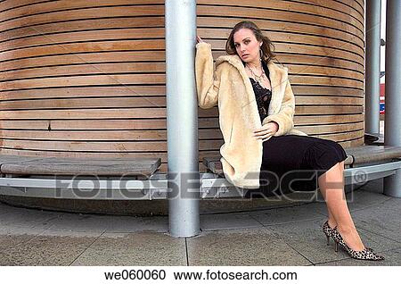 Stock Image - Young female fashion model wearing a fur coat.. Fotosearch