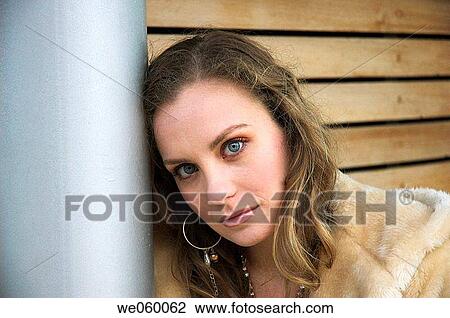 Stock Image - Young female fashion model wearing a fur coat.. Fotosearch
