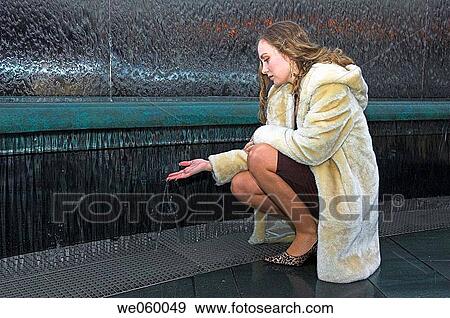 Stock Photo - Young female fashion model wearing a fur coat.. Fotosearch