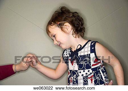 Young girl holding her mother's hand View Large Photo Image Stock Image - Young girl holding her mother's hand. Fotosearch