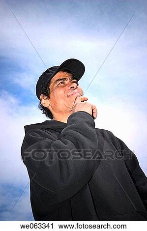 Young Hispanic man, wearing a hat, posing. View Large Photo Image Stock Image - Young Hispanic man, wearing a hat, posing.. Fotosearch