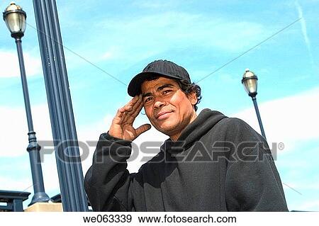 Young Hispanic man, wearing a hat, posing. View Large Photo Image Stock Photo - Young Hispanic man, wearing a hat, posing.. Fotosearch
