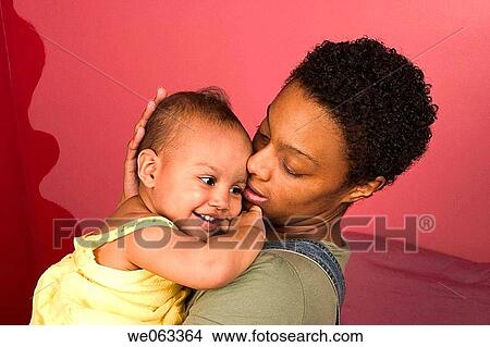 Young Hispanic mother holding her Hispanic/Italian toddler daughter. View Large Photo Image Picture - Young Hispanic mother holding her Hispanic/Italian toddler daughter.. Fotosearch