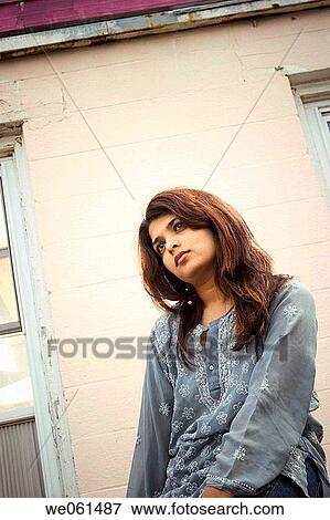 Young Indian woman posing in front of an old motel View Large Photo Image Stock Photo - Young Indian woman posing in front of an old motel. Fotosearch