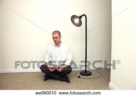 Young man sitting cross legged in minamilist office environment. Pose is suggestive of contemplation or meditation. The new business owner in their as yet unfurnished office. View Large Photo Image Stock Image - Young man sitting cross legged in minamilist office environment. Pose is suggestive of contemplation or meditation. The new business owner in their as yet unfurnished office.. Fotosearch