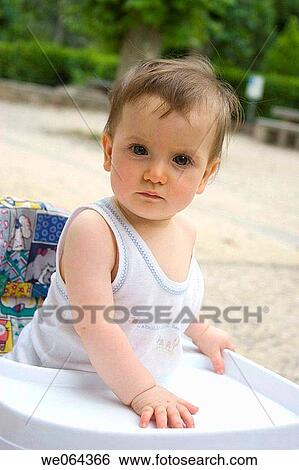 14 month old baby girl, outside, standing in a walker, looking into camera with a serious expression View Large Photo Image Stock Photograph - 14 month old baby girl, outside, standing in a walker, looking into camera with a serious expression. Fotosearch