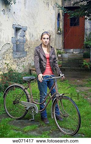 Stock Photo - 17 year old girl with bike. Fotosearch