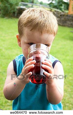 2 year old boy drinking out of a pint class lookin into camera View Large Photo Image Stock Image - 2 year old boy drinking out of a pint class lookin into camera. Fotosearch