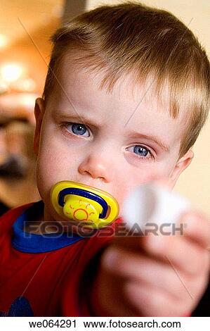 2 year old boy, headshot, holding a toy out towards the camera View Large Photo Image Stock Image - 2 year old boy, headshot, holding a toy out towards the camera. Fotosearch
