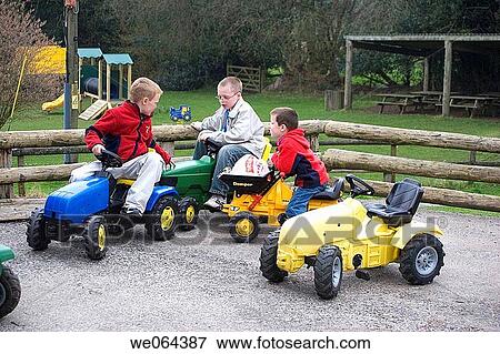 3, 4_ 5 year old boys, playing on toy tracters, chatting to each other View Large Photo Image Stock Photo - 3, 4_ 5 year old boys, playing on toy tracters, chatting to each other. Fotosearch