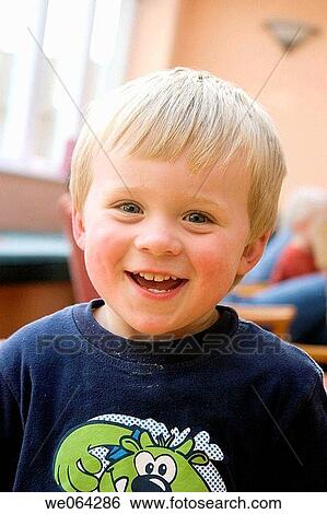 Stock Photograph - 3 year old boy smiling into camera, headshot. Fotosearch