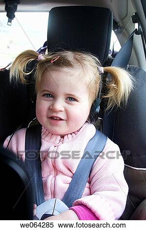 3 year old girl looking into camera, in the car, wearing headphones View Large Photo Image Stock Photography - 3 year old girl looking into camera, in the car, wearing headphones. Fotosearch