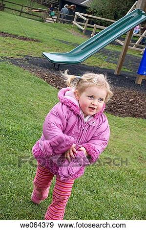 3 year old girl outside, running in the park, smiling View Large Photo Image Stock Photo - 3 year old girl outside, running in the park, smiling. Fotosearch