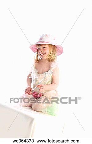 3 year old girl sitting on abox in the studio, wearing a fairy dress, holding a wand, smiling off camera View Large Photo Image Stock Image - 3 year old girl sitting on abox in the studio, wearing a fairy dress, holding a wand, smiling off camera. Fotosearch