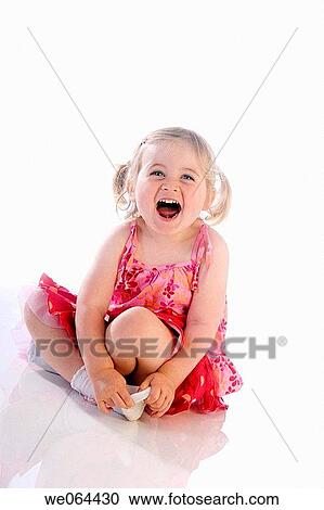 3 Year old girl sitting with leggs crlssed on the studio floor, on the studio floor laughing View Large Photo Image Stock Image - 3 Year old girl sitting with leggs crlssed on the studio floor, on the studio floor laughing. Fotosearch