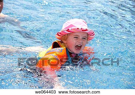 3 year old girl swimming in the pool with armbands laughing View Large Photo Image Stock Image - 3 year old girl swimming in the pool with armbands laughing. Fotosearch