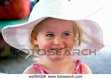 3 year old girl wearing a big sunhat amiling off camera View Large Photo Image Stock Photo - 3 year old girl wearing a big sunhat amiling off camera. Fotosearch