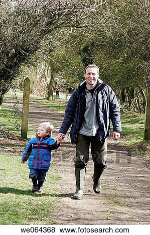 45 year old man walking in the park, with his 3 year old son View Large Photo Image Stock Photo - 45 year old man walking in the park, with his 3 year old son. Fotosearch