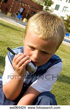 5 year old boy outside talking into a walkie talkie View Large Photo Image Picture - 5 year old boy outside talking into a walkie talkie. Fotosearch