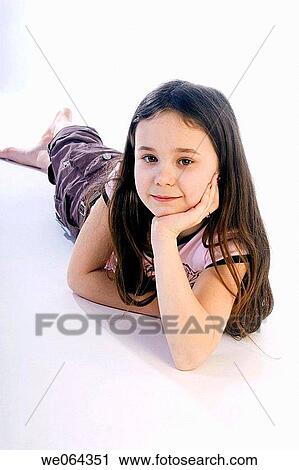 5 year old girl lying on the studio floor, smiling into camera View Large Photo Image Stock Image - 5 year old girl lying on the studio floor, smiling into camera. Fotosearch
