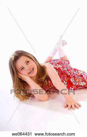 5 Year old girl lying on the studio floor on her tummy, smiling off camera View Large Photo Image Stock Image - 5 Year old girl lying on the studio floor on her tummy, smiling off camera. Fotosearch