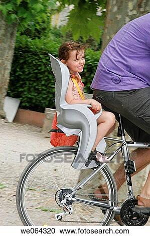 5 year old girl sitting in the child seat on the back of a bycicle View Large Photo Image Stock Image - 5 year old girl sitting in the child seat on the back of a bycicle. Fotosearch