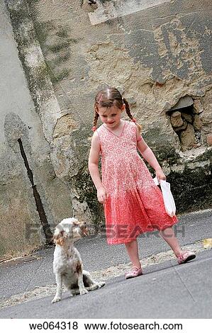 5 year old girl walking next to a dog smiling down at it View Large Photo Image Stock Photo - 5 year old girl walking next to a dog smiling down at it. Fotosearch