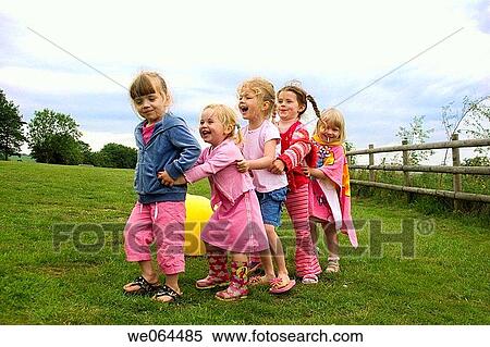 5 young girls playing follow my leader in a field View Large Photo Image Stock Photography - 5 young girls playing follow my leader in a field. Fotosearch