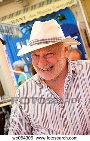 70 year old man sitting in a cafe outside, smile into camera View Large Photo Image Stock Photograph - 70 year old man sitting in a cafe outside, smile into camera. Fotosearch