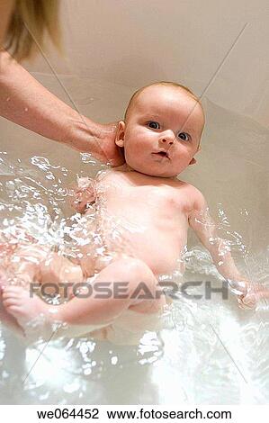 8 week old baby inthe bath looking into camera with a very serious expression View Large Photo Image Stock Image - 8 week old baby inthe bath looking into camera with a very serious expression. Fotosearch